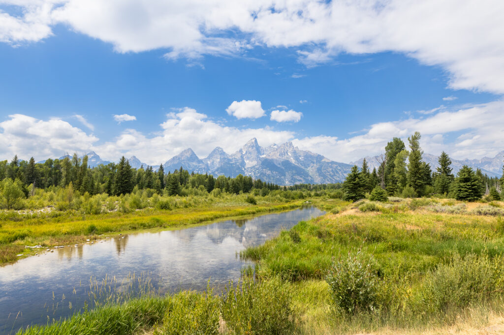 The Grand Tetons reflect off of the snake river